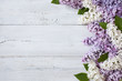 A wooden background with flowering lilac branches