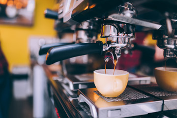 Wall Mural - Details of barista preparing fresh espresso on industrial brewing machinery