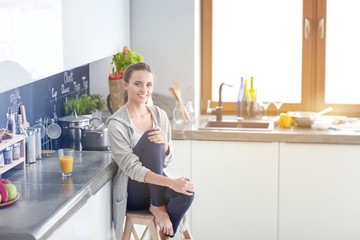 Woman in the kitchen. Cooking at kitchen.