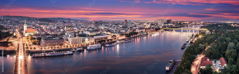 Obraz na płótnie Aerial panorama of Bratislava, new bridge over Danube river with evening lights in capital city of Slovakia,Bratislava w salonie