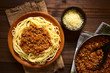 Spaghetti with homemade bolognese sauce made of fresh tomato, mincemeat, onion, garlic and carrot, photographed overhead with natural light
