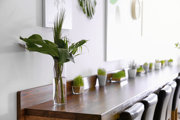 Wall Mural - Modern cafe interior with wooden counter and chairs