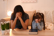 © Africa Studio - Religious Christian girl and her mother praying at home