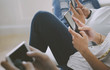 © Rawpixel.com - Friends using smartphone together at home
