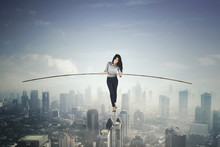 Beautiful Businesswoman Balancing On A Rope