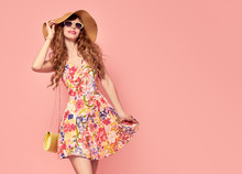 Portrait Of Fashion Young Woman In Floral Dress. Pretty Girl In Hat, Sunglasses. Female Model In Stylish Summer Outfit. Pink Yellow Vanilla Color. Beautiful Lady. Vintage