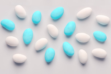 top down of blue and white sugared almond candies like festive background with copy space