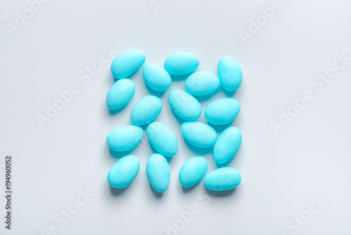 flat lay of blue sugared almond candies square shape on background from above
