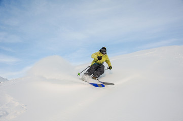 Wall Mural - Professional snowboarder sliding down the snowy hill