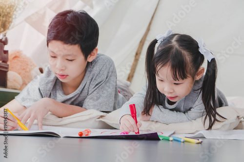 Happy Asian Little Cute Girl And Boy Drawing And Painting Color On