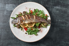 Hot Fresh Delicious Roasted Whole Trout Barbecue With Fresh Herbs And Lemon, On A Wooden Background Top View Close-up
