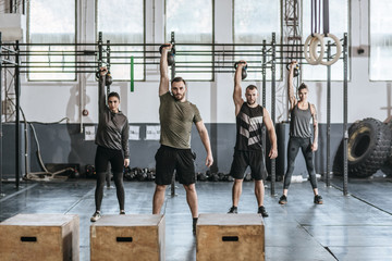 Sportsmen and Sportswomen Lifting Weights at Gym