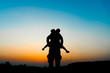 © ananaline - Silhouette the son is riding his father's neck.