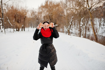 Funny brunette girl outdoor on winter with two pieces of pizza.