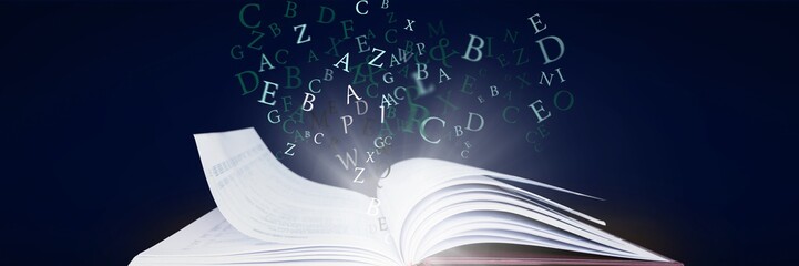 Wall Mural - opened book with light and letters on dark blue background