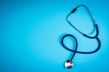 Stethoscope on blue background. Medical background. Doctor equipment. Medicine, medical examination, health care concept. Copy space, top view