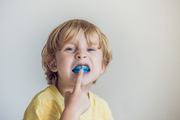 Three-year old boy shows myofunctional trainer to illuminate mouth breathing habit. Helps equalize the growing teeth and correct bite. Corrects the position of the tongue