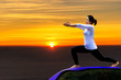 Sporty young woman doing yoga practice with sky background - concept of healthy life and natural balance between body and mental development
