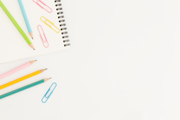 Wall Mural - flat lay photo of office desk with colorful pencil and paper clip,copy space top view