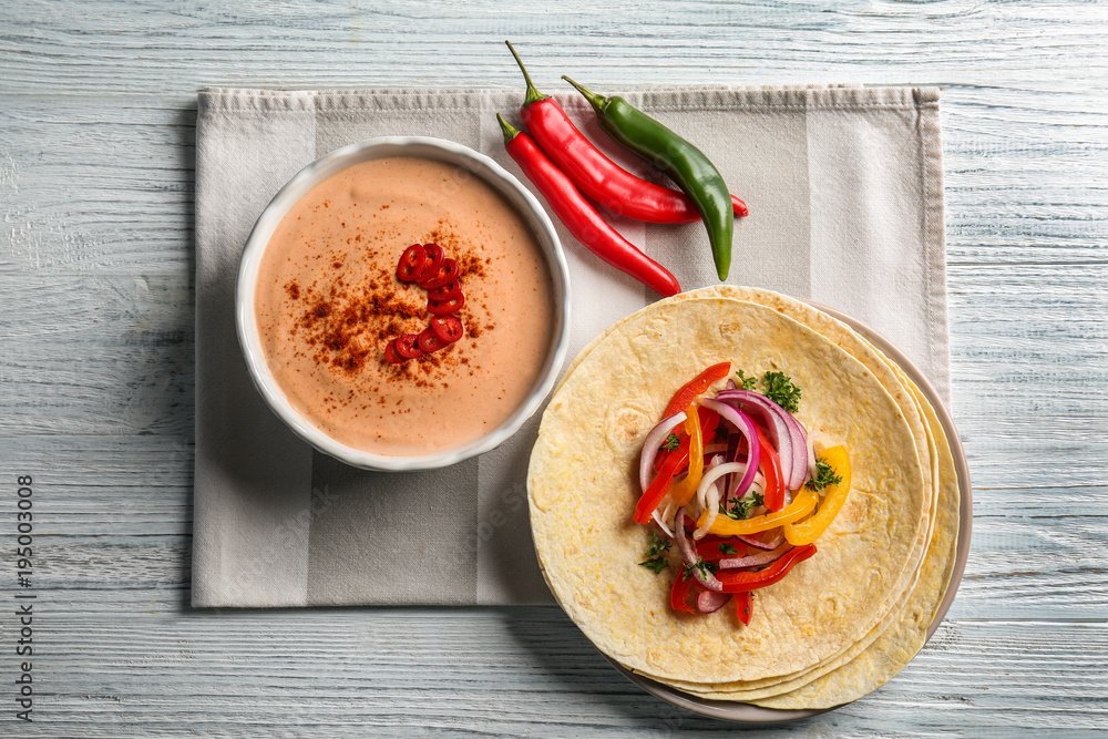 Tasty creamy sauce for fish taco in bowl on kitchen table