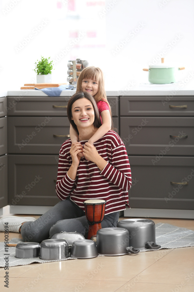 Mother and her daughter having fun in kitchen at home