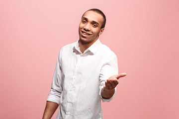 The happy business man point you and want you, half length closeup portrait on pink background.