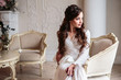 © cherry_d - Beautiful bride in a white wedding peignoir in a morning. beauty portrait in interior