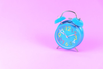 Blue Alarm clock on pink pastel background or isolated