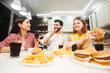 © proimagecontent - Cute young guys having friendly and joyful talk while having fast food meal, indoor shot in cozy white kitchen