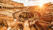 Inside the Colosseum or Coliseum in Rome, Italy. Panorama at sunset.