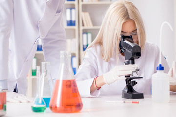 two chemists having discussion in lab