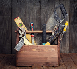 Wall Mural - grungy old tools on a wooden background front view.