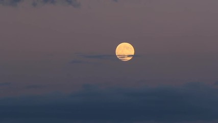 Wall Mural - Full shining moon rising up on dark sky, time lapse