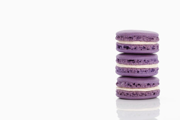 Assorted macaroons over white background with reflection.