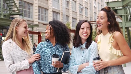 Wall Mural - Female work friends laughing outside their workplace