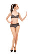 © rs31 - The girl stops someone with a gesture of the hand. Young beautiful girl in black lingerie isolated on white background