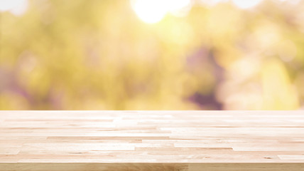 Poster - Wood table top on blur abstract natural foliage bokeh background, vintage tone