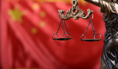 Wall Mural - Scales of Justice, Justitia, Lady Justice in front of the flag of China in the background.