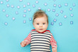 © triocean - Portrait of adorable 3 months old baby on the blue background, studio shot