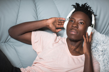 Wall Mural - African-American man in headphones listening to music