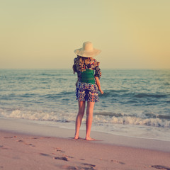 Wall Mural - Closeup on mother and child legs by the beach shore outdoors tranquil nature background. Active caring female coastline walking, healthy beauty free leisure aspiration lifestyle scene. Back side view