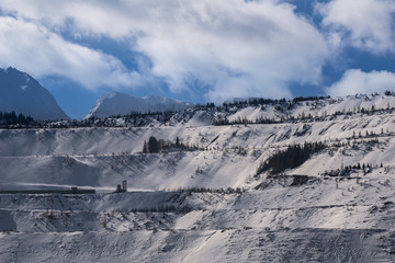 Large open pit mine covered in snow in winter