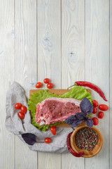 Wall Mural - raw meat with ingredients on a wooden background