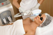 Beautiful woman in beauty salon during photo rejuvenation procedure