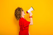 © Ivan Traimak - Attractive woman with curly hair with loudspeaker