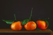fresh ripe tangerines, rustic food photography on slate plate kitchen table can be used as background