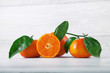 fresh ripe tangerines, rustic food photography on white wood plate kitchen table can be used as background