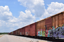 Old Rusty Train Cars With Graffiti On Sunny Day.