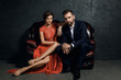 © blackday - Attractive young couple is sitting on the leather sofa