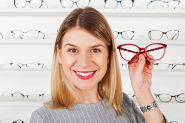 Poster - Woman choosing eyeglass frame